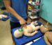 A man is demonstrating CPR techniques on a dummy in a training room for American Heart Association classes_CPR certification Augusta_CPR certification Augusta GA_AHA CPR classes online